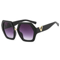Black sunglasses with gold accents and purple lenses on a white background