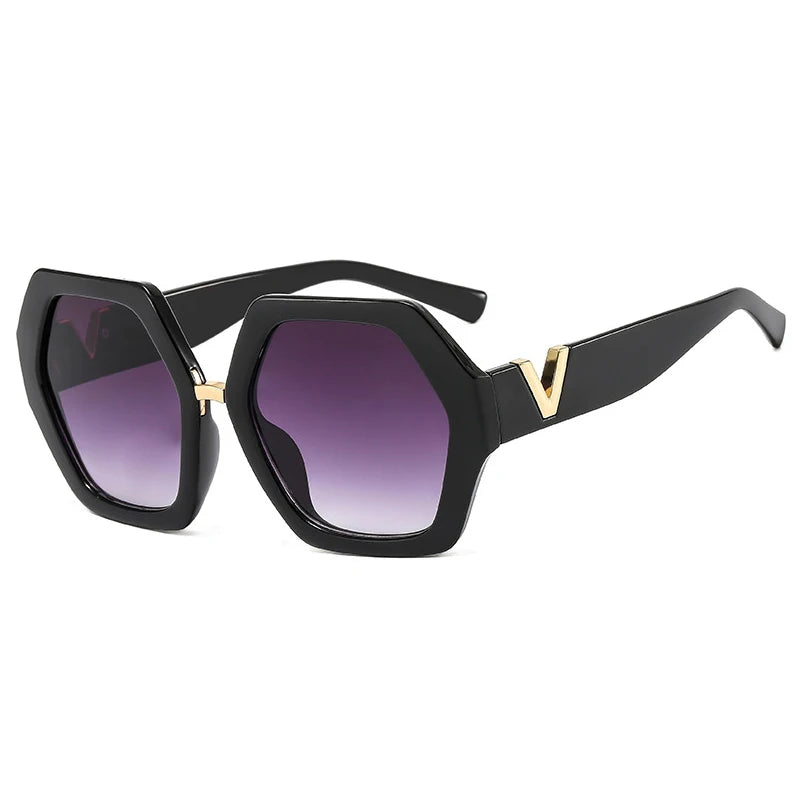 Black sunglasses with gold accents and purple lenses on a white background