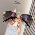 Sunglasses with gold accents held by a hand against a neutral background