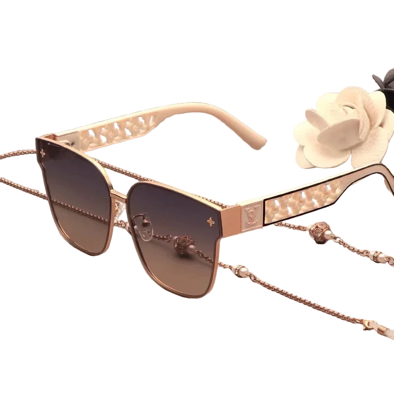 Sunglasses with decorative chain and embellishments on a white background