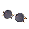 Round sunglasses with gold frames on a black background