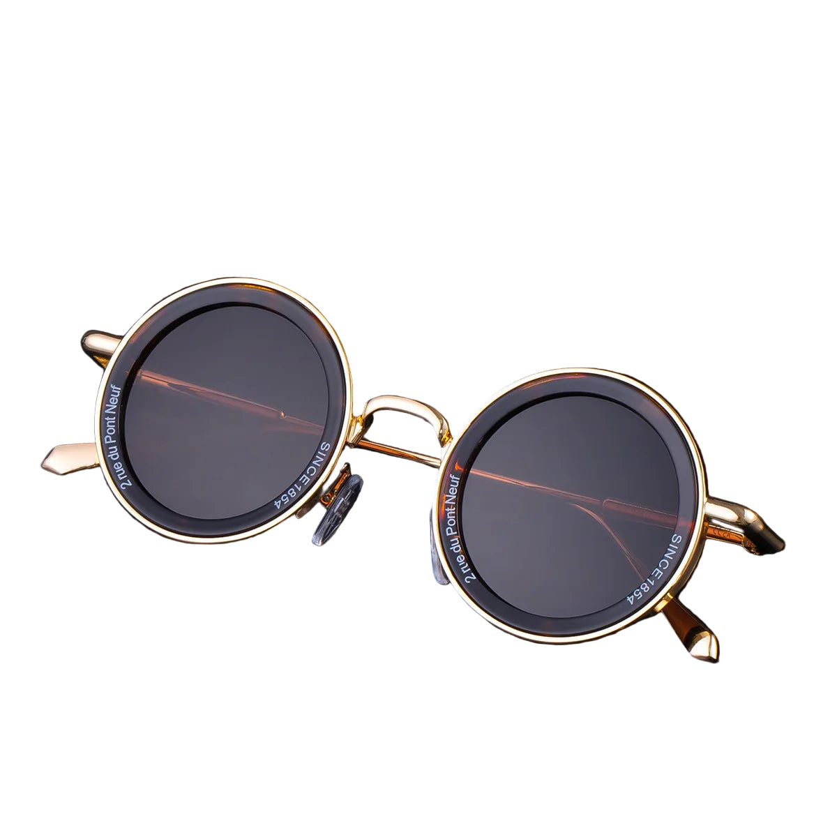 Round sunglasses with gold frames on a black background