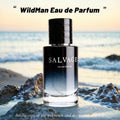 Salvage WildMan Eau de Parfum bottle on a beach with ocean waves in the background