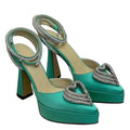 Turquoise high-heeled shoes with silver heart embellishments on a white background
