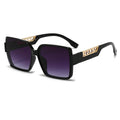 Black sunglasses with gold accents on a white background