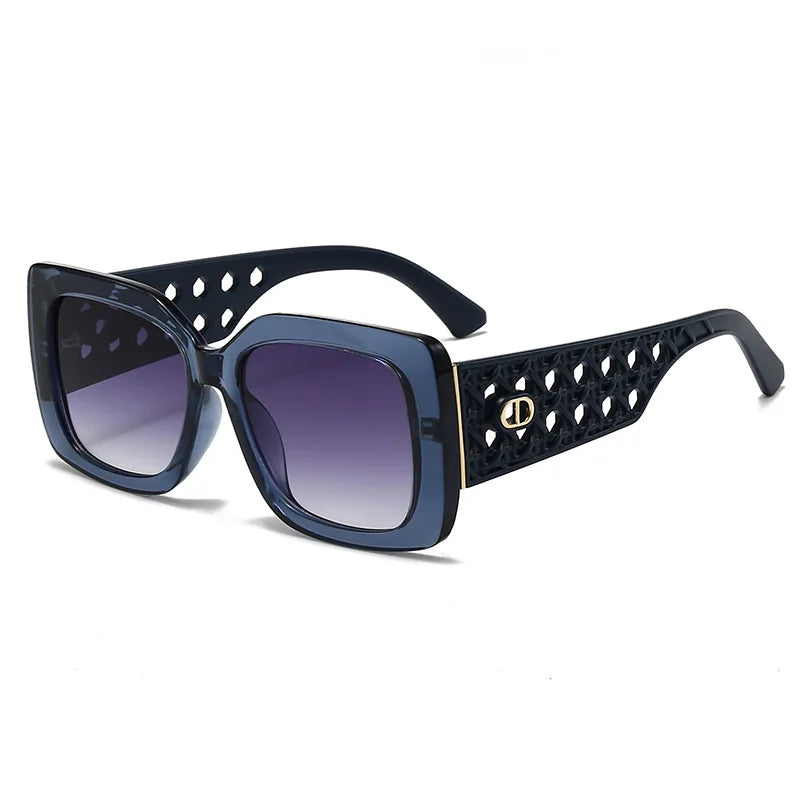 Sunglasses with decorative black frame and brown gradient lenses on a white background