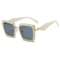 Gold-framed sunglasses with dark lenses on a white background
