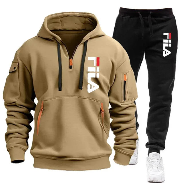 Tan hoodie and black pants with Fila logo on a white background