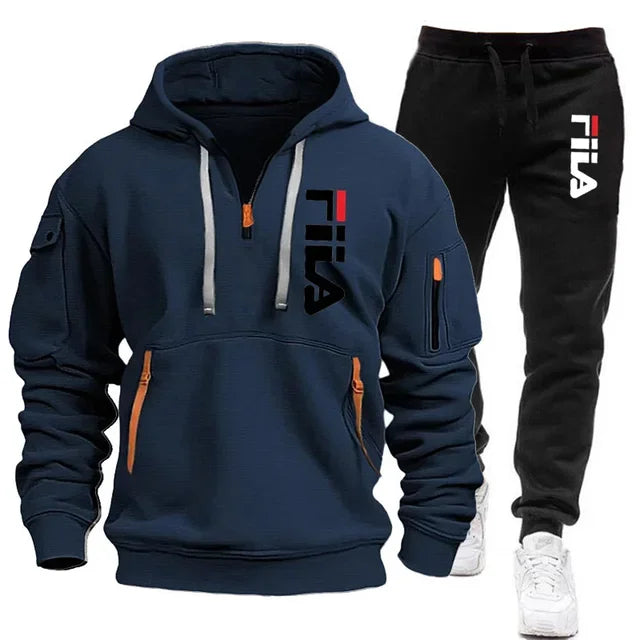 Navy hoodie with FILA logo and black pants on a white background