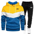 Color-blocked hoodie and black pants with Adidas logo on a white background