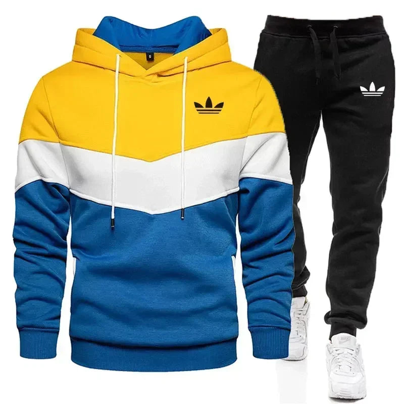 Color-blocked hoodie and black pants with Adidas logo on a white background