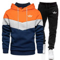 Color-blocked hoodie and black pants with Adidas logo on a white background