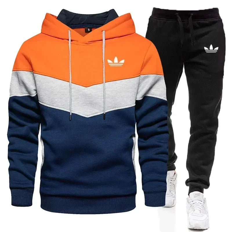 Color-blocked hoodie and black pants with Adidas logo on a white background
