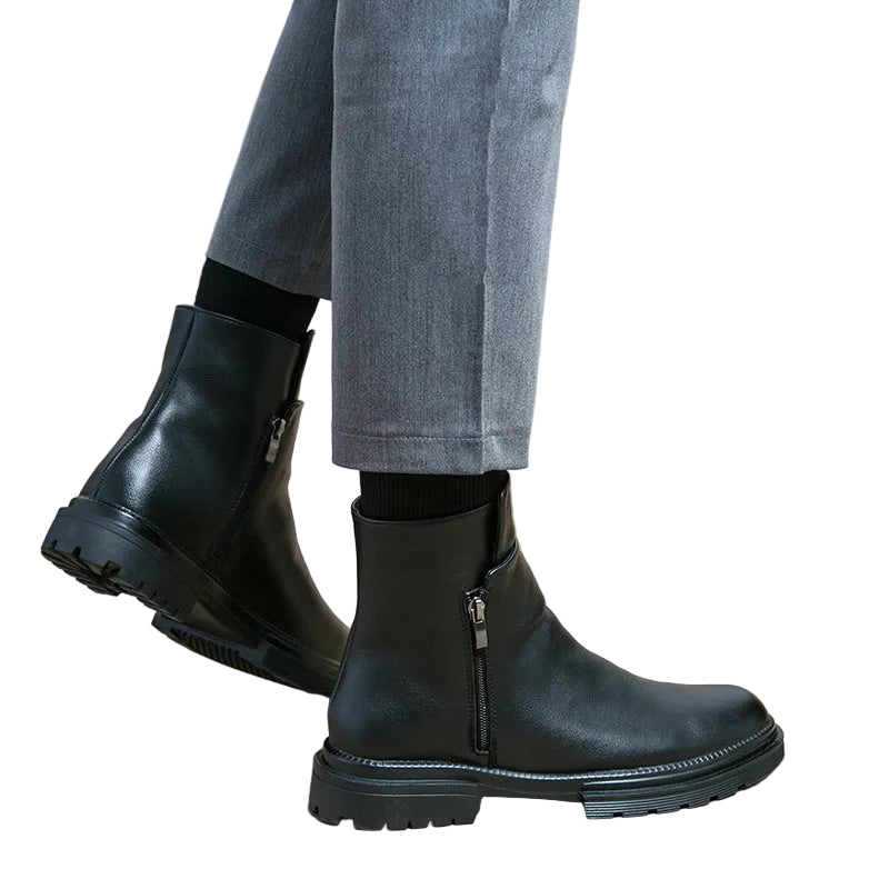 Brown leather boots worn with gray pants on a white background