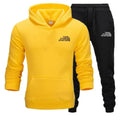 Yellow hoodie and black pants with 'The Storm Sports' logo on a white background