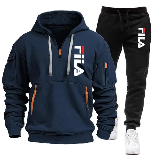 Navy hoodie and black pants with Fila logo on a white background
