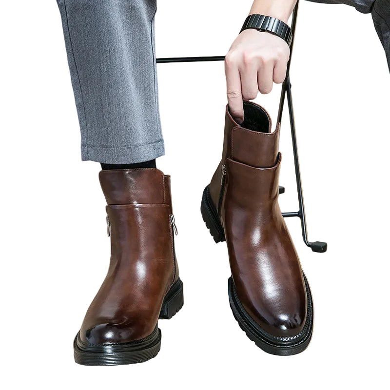 Brown leather boots worn with gray pants on a white background