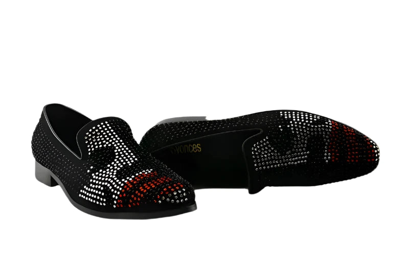 A pair of men's luxury crystal studded slip-on loafers in black with red and white accents.