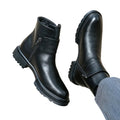 Black leather boots with zippers on a white background