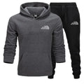 Gray hoodie and black pants set with 'The Storm Sports' logo on a white background