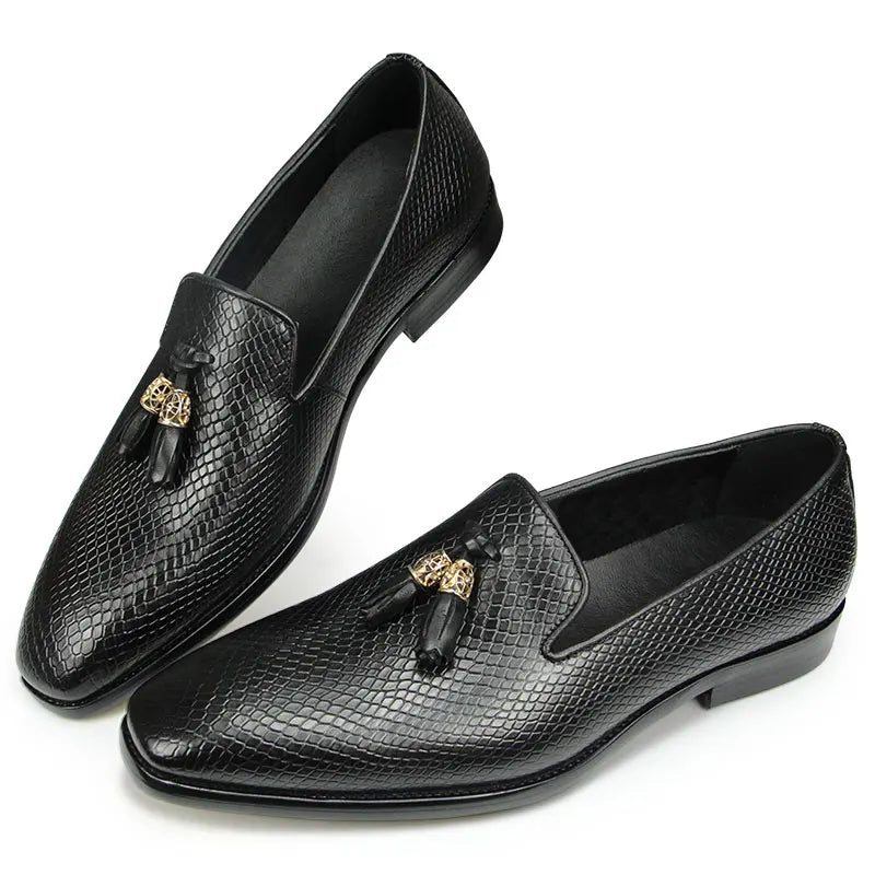 A pair of brown handmade tassel loafers with a pigskin insole and a shallow tassel design on the vamp.