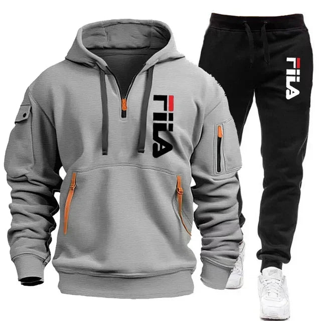 Gray hoodie and black pants with Fila logo on a white background