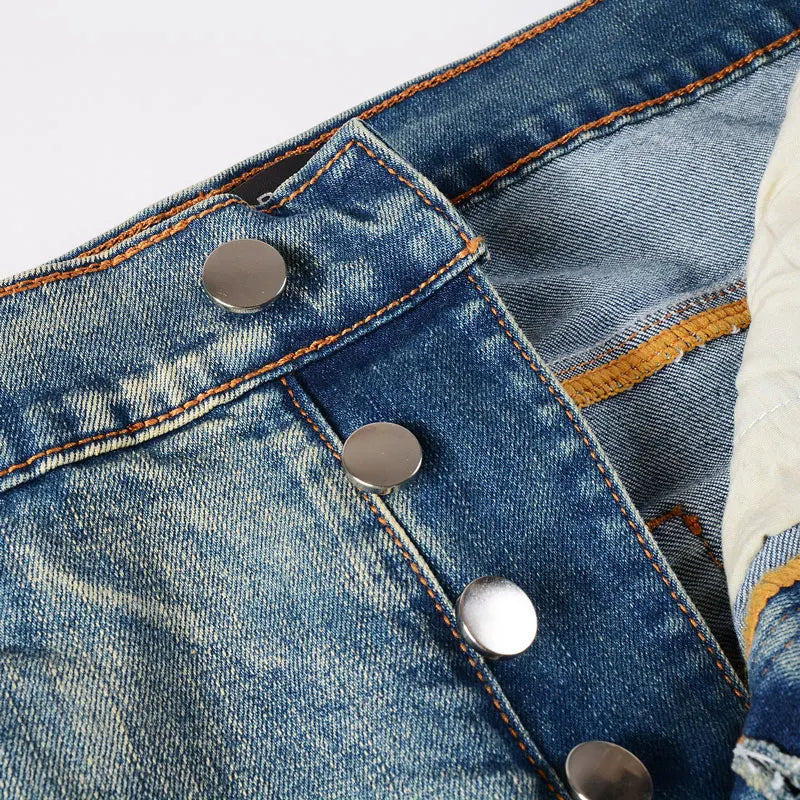 Close-up of a blue denim jacket with metal buttons on a light gray background