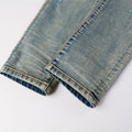 Close-up of rolled-up blue denim jeans on a white background