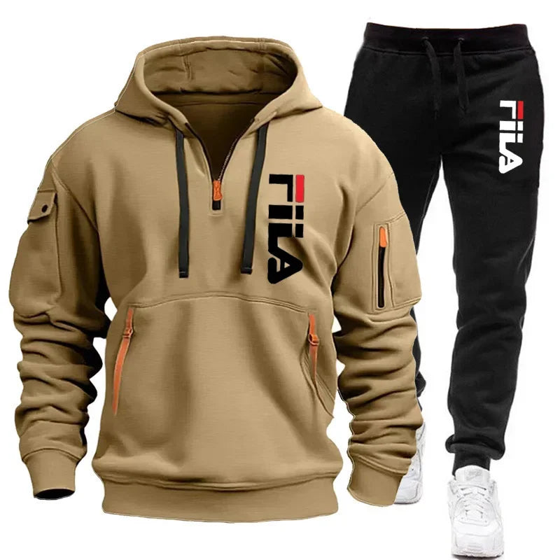 Tan hoodie and black pants with Fila logo on a white background