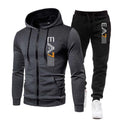 Gray hoodie and black pants with a logo on a white background