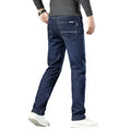 Person wearing blue jeans on a white background