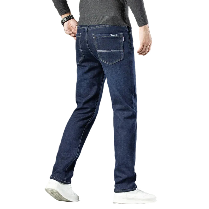 Person wearing blue jeans on a white background