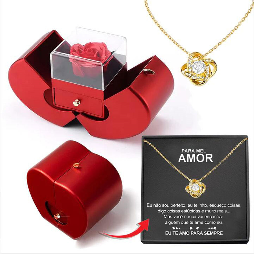 Red jewelry box with a gold necklace and heart-shaped pendant on a white background