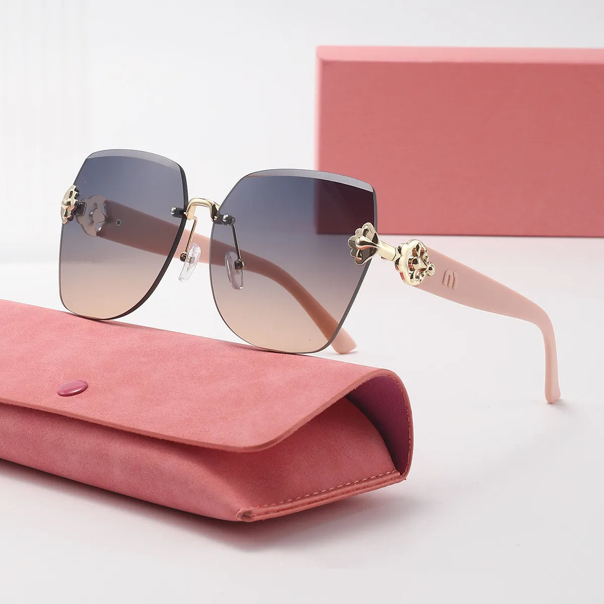 Sunglasses with pink case on a light background