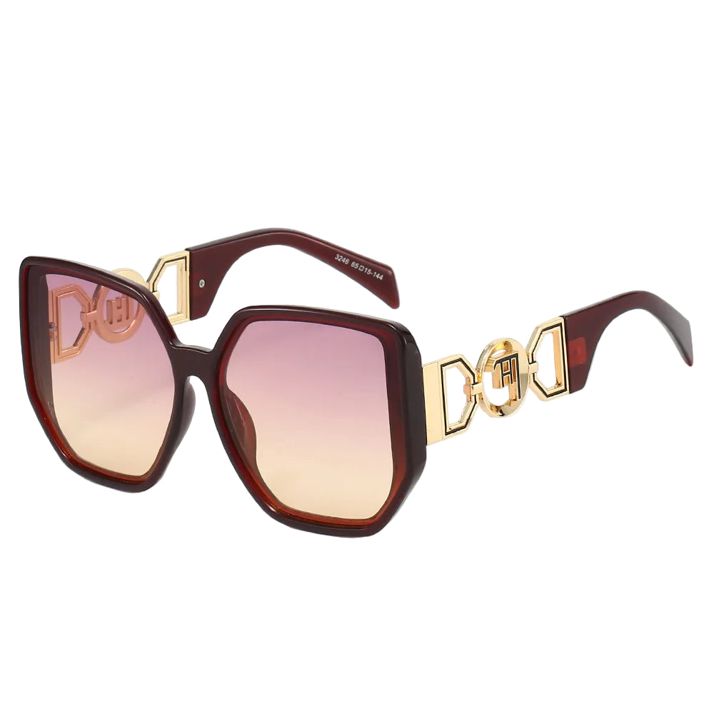 Sunglasses with gold accents and gradient lenses on a white background
