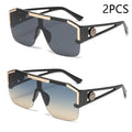 Two pairs of sunglasses with black and gold frames on a white background.