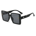 Black sunglasses with a gold logo on a white background