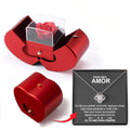 Red jewelry box with a rose and a necklace with a heart pendant on a white background