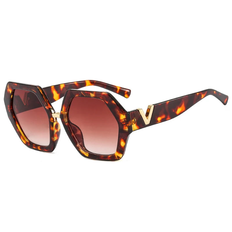 Sunglasses with tortoiseshell frame and brown lenses on a white background