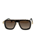 Black and gold sunglasses with brown lenses on a light gray surface, featuring the brand 'DITAA'.