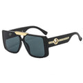 Black sunglasses with gold accents on a white background