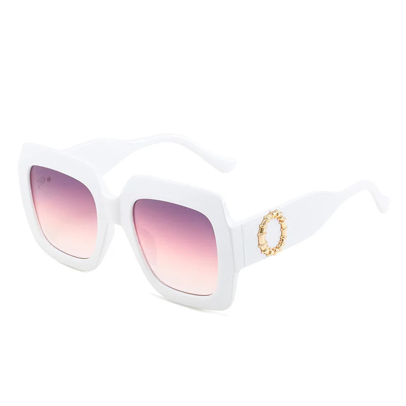 Person wearing large black sunglasses with a brand logo in the corner