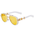 Sunglasses with yellow lenses and gold frames on a white background