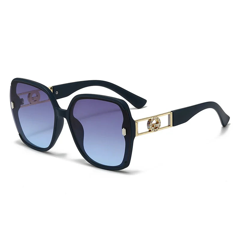 Sunglasses with black frame and blue gradient lenses on a white background