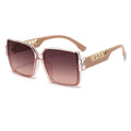 Sunglasses with gold frame and brown gradient lenses on a white background