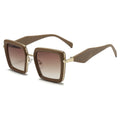 Brown sunglasses with gold frame on a white background