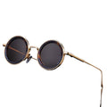 Round sunglasses with gold frame and dark lenses on a white background