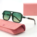 Green sunglasses with a pink case on a white background