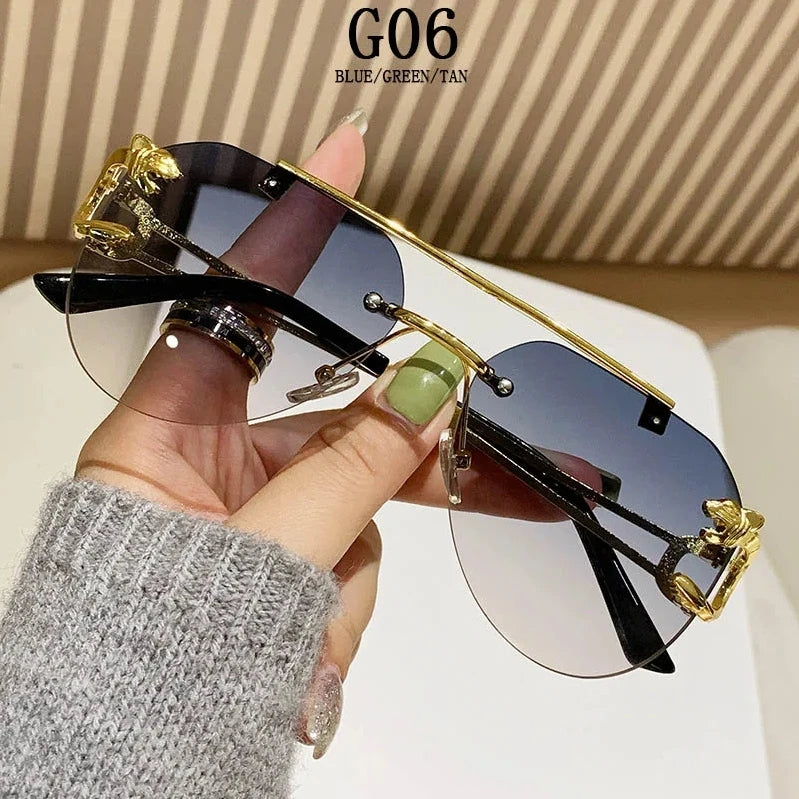 Sunglasses with gold accents held by a hand against a neutral background