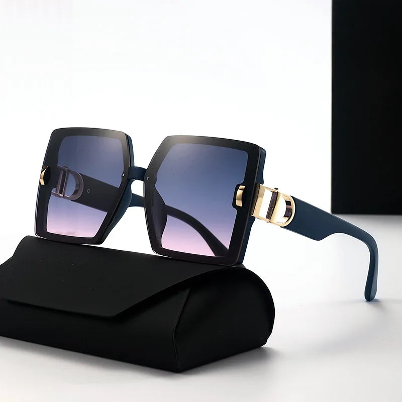 Sunglasses with black frame and gold accents on a black case against a white background